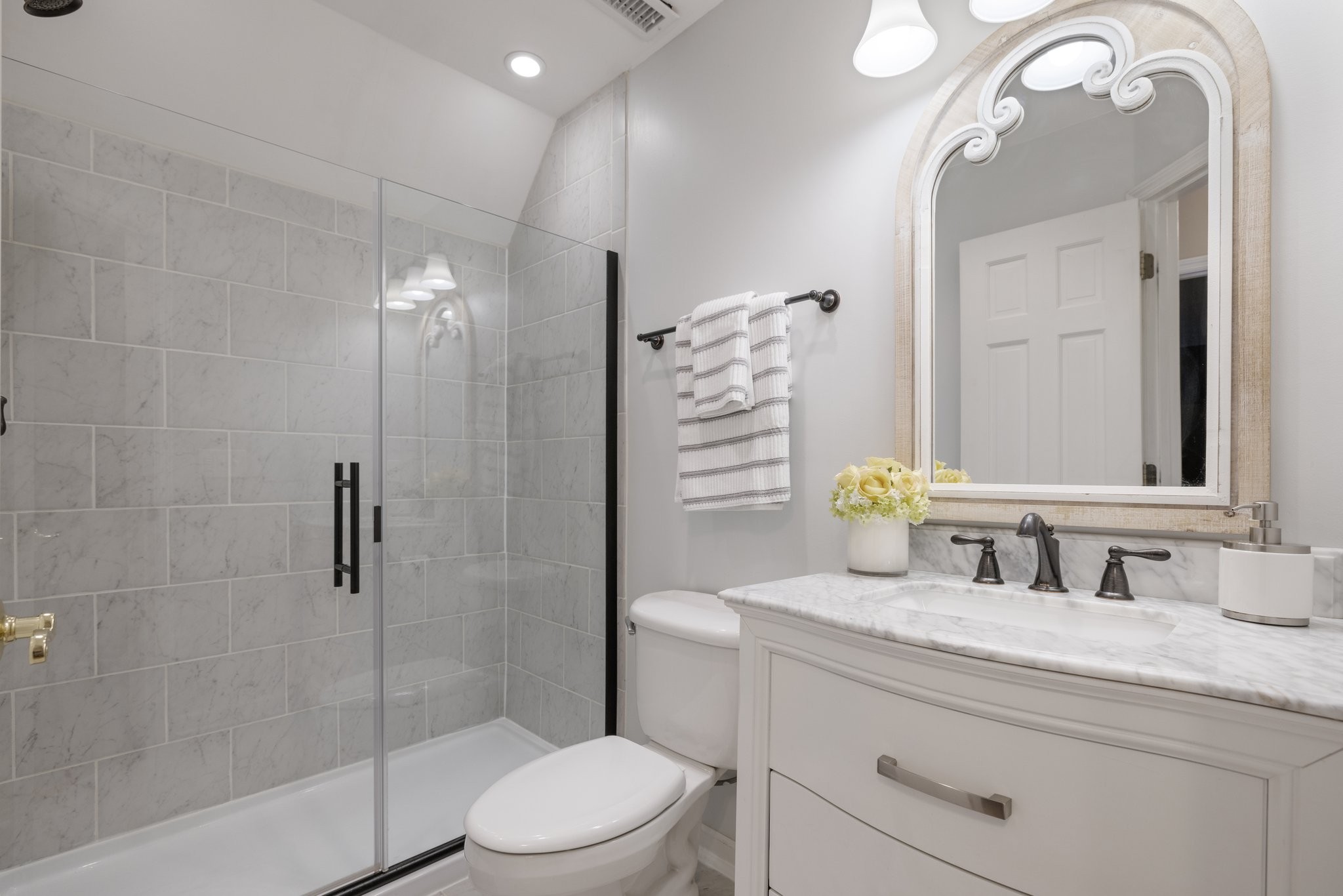 5375 Murfreesboro Road College Grove, TN 37046 - Photo 47 of 70 a bathroom with a toilet a sink a glass door a shower a mirror and vanity