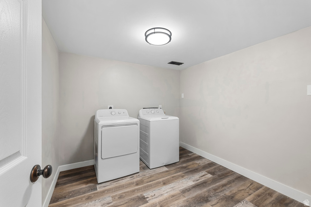 523 South Main Street Payson, UT 84651 - Photo 31 of 41 Dedicated laundry space featuring wood-finish flooring, light neutral wall tones, and a modern flush-mount ceiling light fixture