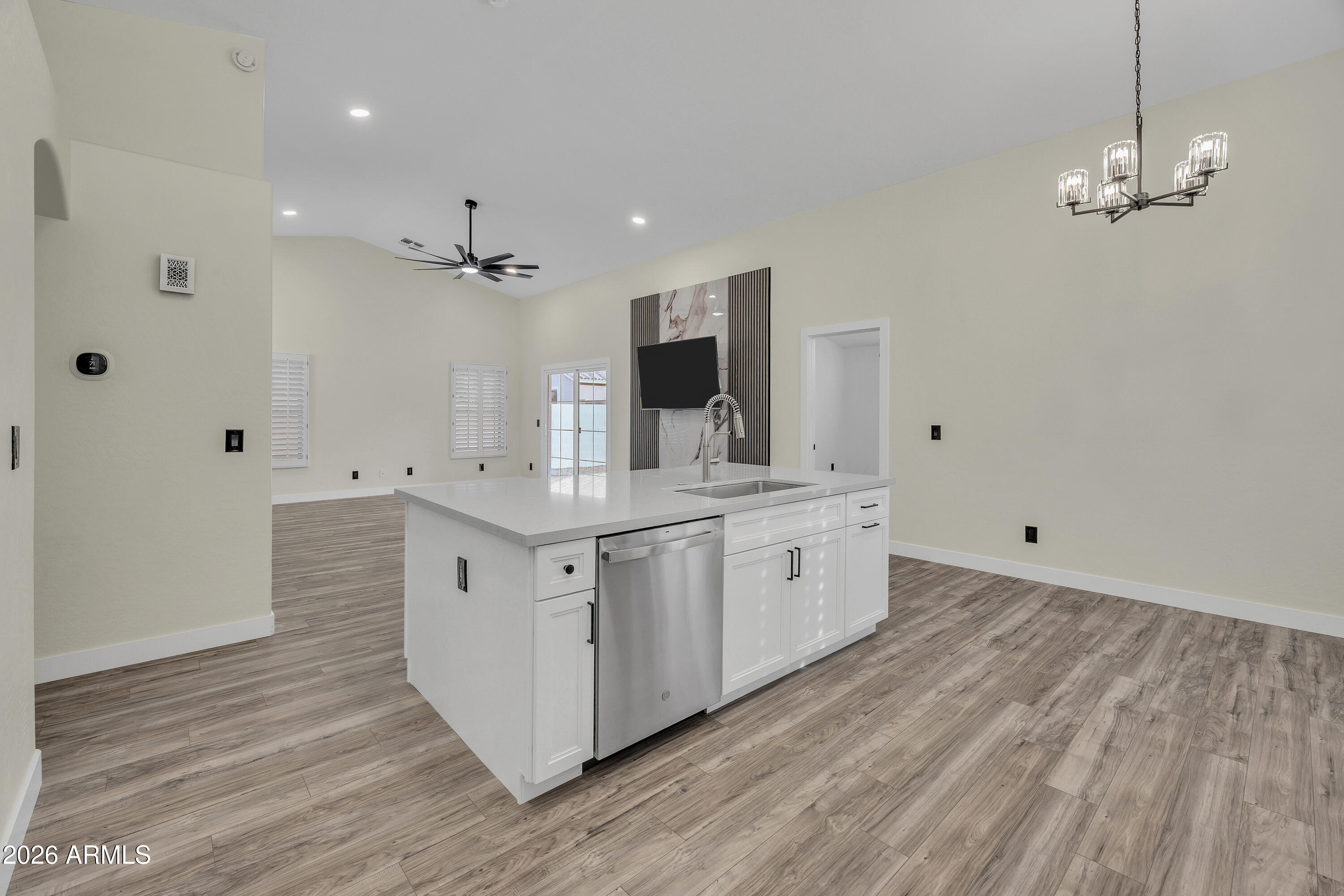a large white bathroom with a double vanity sink a mirror and shower