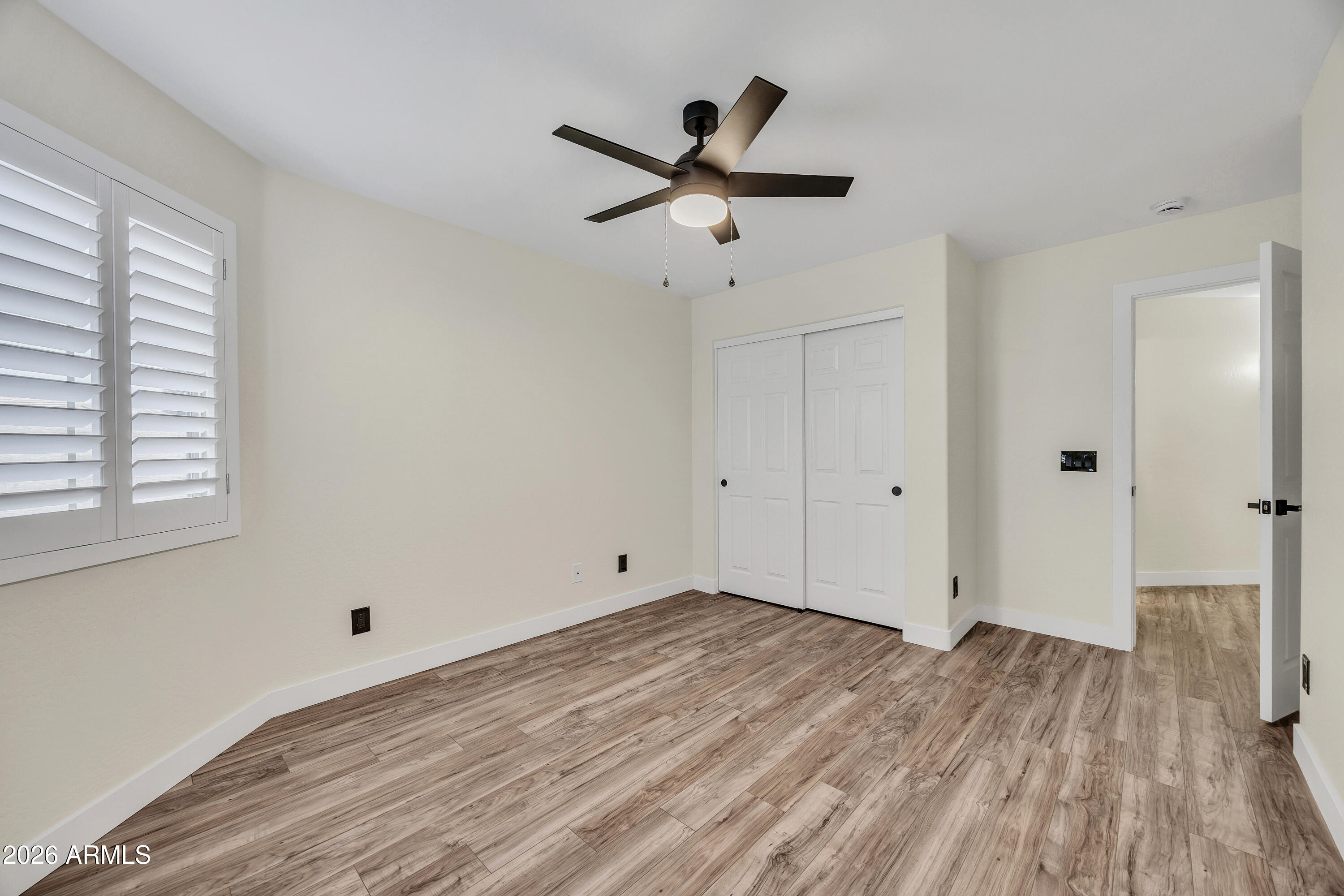 3283 East Bonanza Road Gilbert, AZ 85297 - Photo 18 of 31 a view of empty room with wooden floor and fan