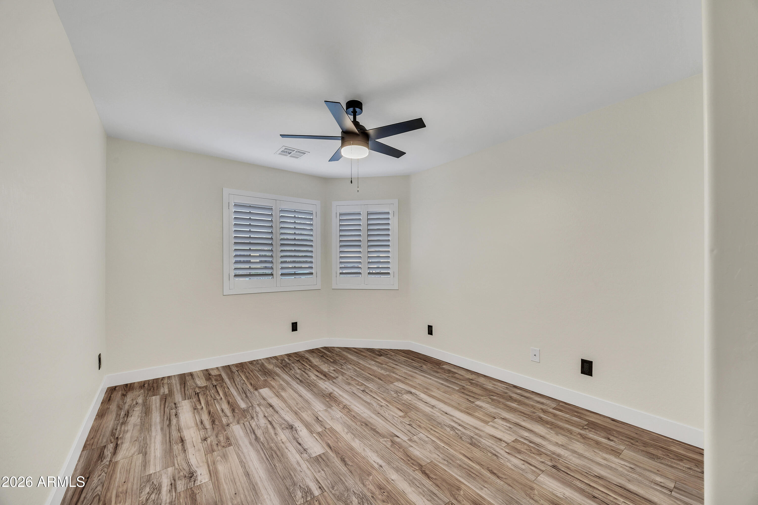 3283 East Bonanza Road Gilbert, AZ 85297 - Photo 19 of 31 a view of empty room with wooden floor and fan