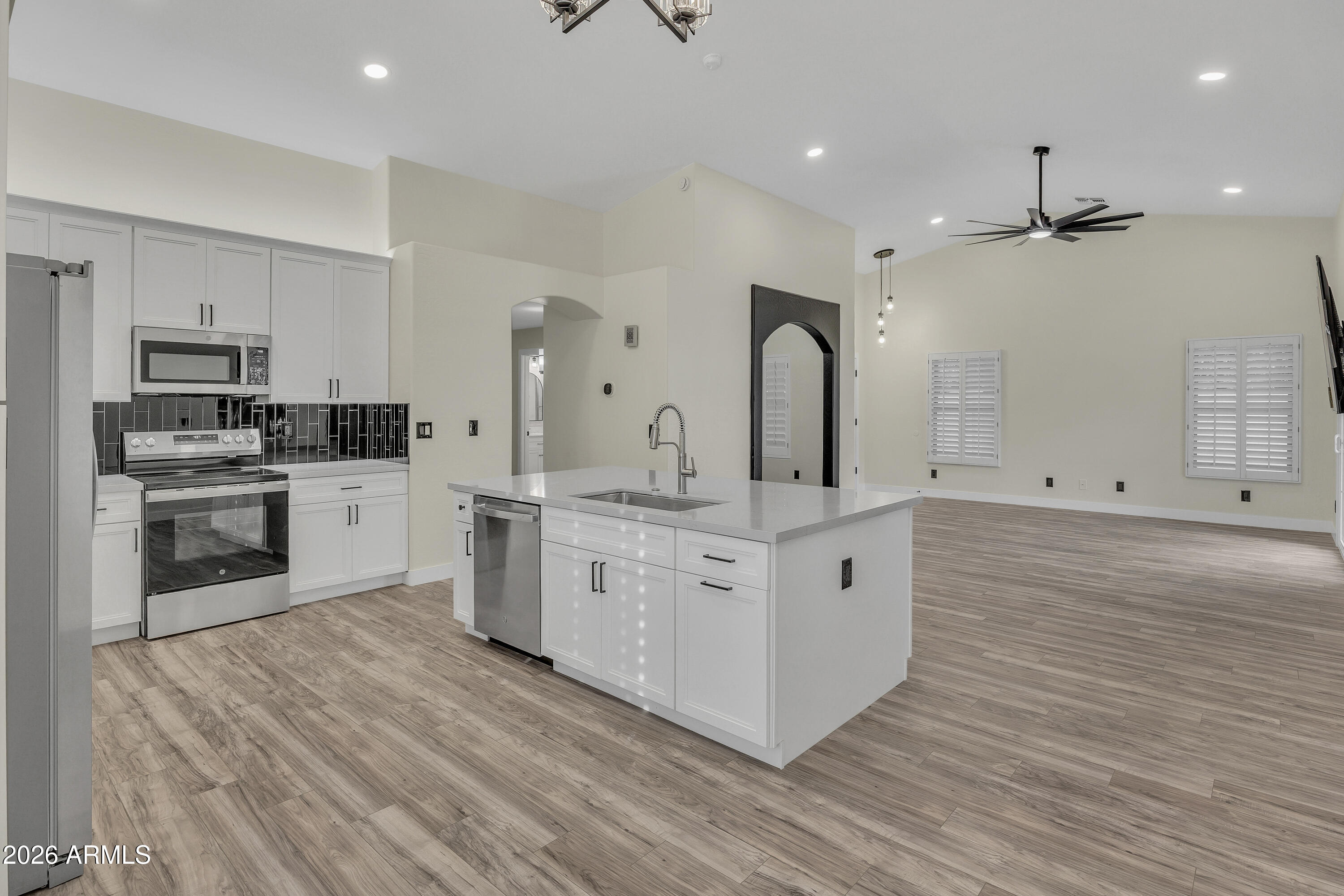 3283 East Bonanza Road Gilbert, AZ 85297 - Photo 2 of 31 a kitchen with white cabinets and stainless steel appliances