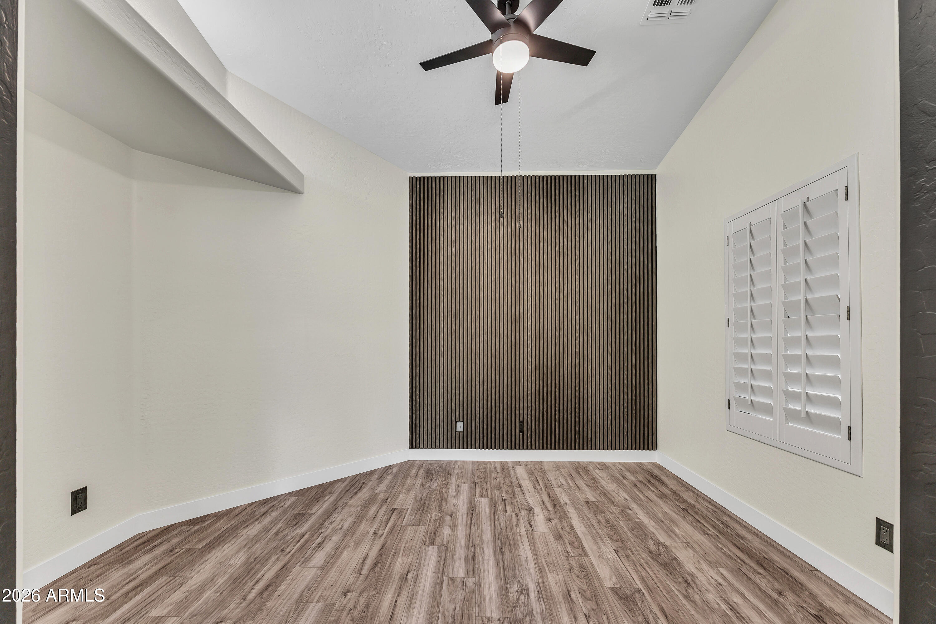 3283 East Bonanza Road Gilbert, AZ 85297 - Photo 23 of 31 wooden floor in an empty room with a window