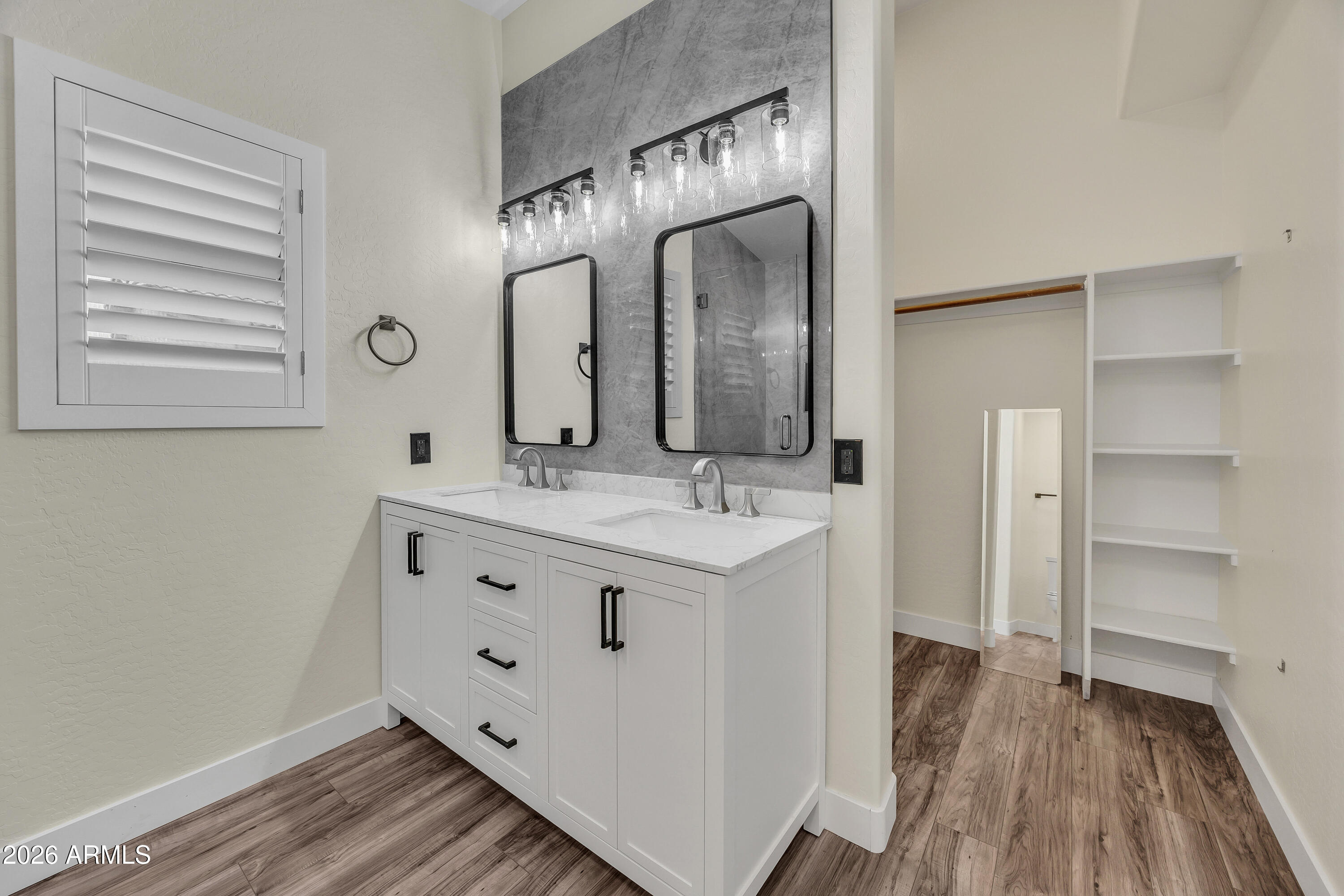 3283 East Bonanza Road Gilbert, AZ 85297 - Photo 26 of 31 a bathroom with a double vanity sink and a mirror