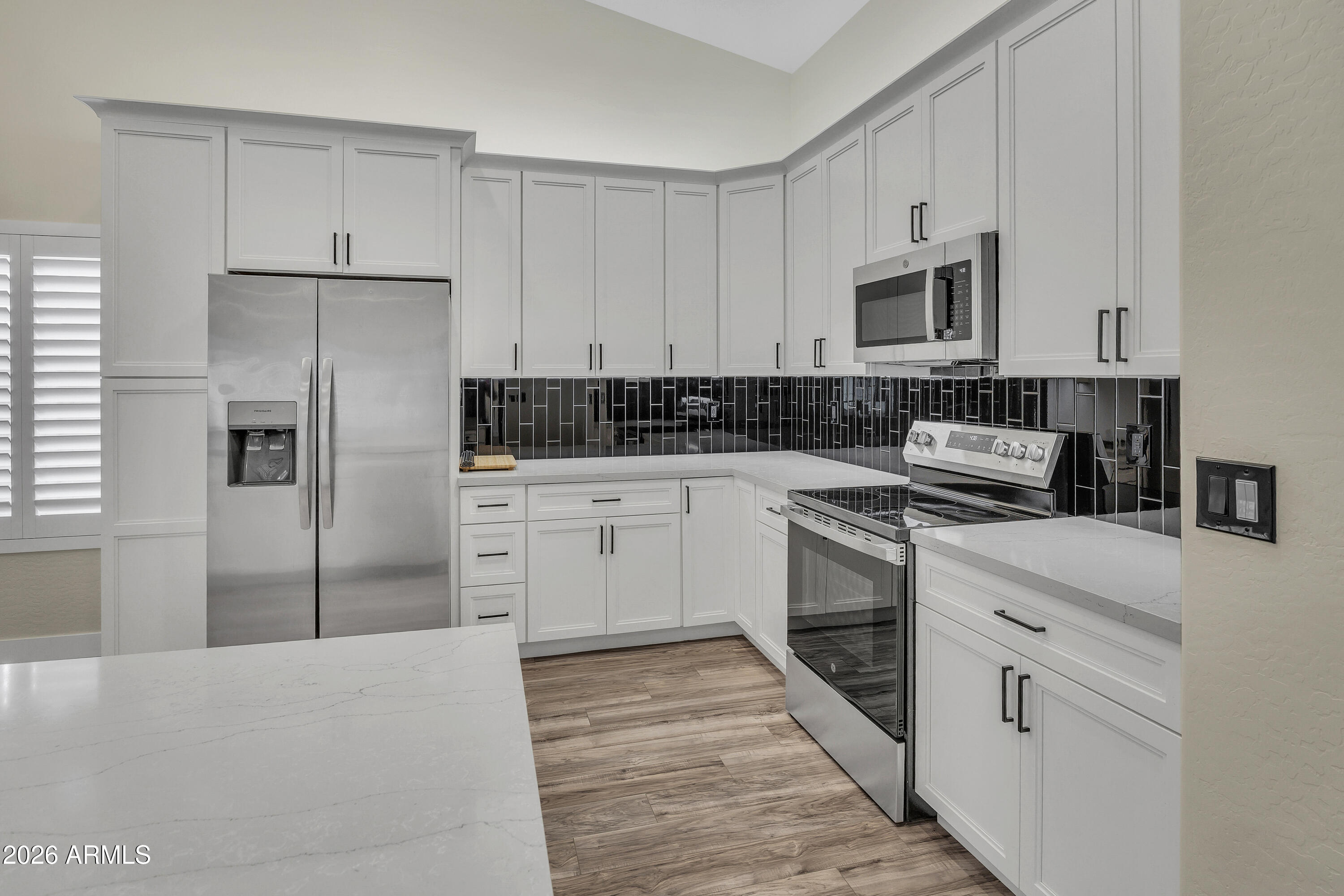 3283 East Bonanza Road Gilbert, AZ 85297 - Photo 30 of 31 a kitchen with white cabinets and white appliances