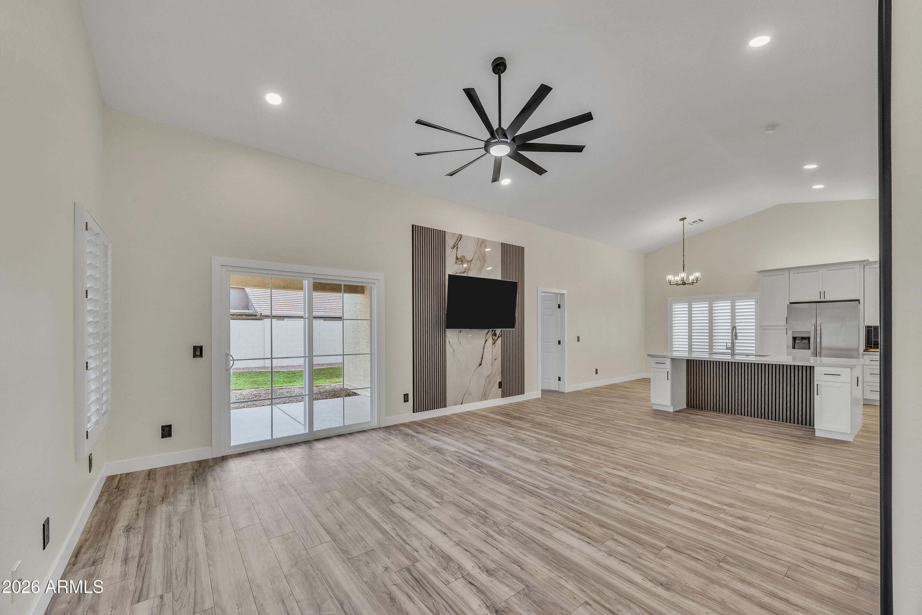 3283 East Bonanza Road Gilbert, AZ 85297 - Photo 9 of 31 a view of a kitchen with wooden floor and a ceiling fan