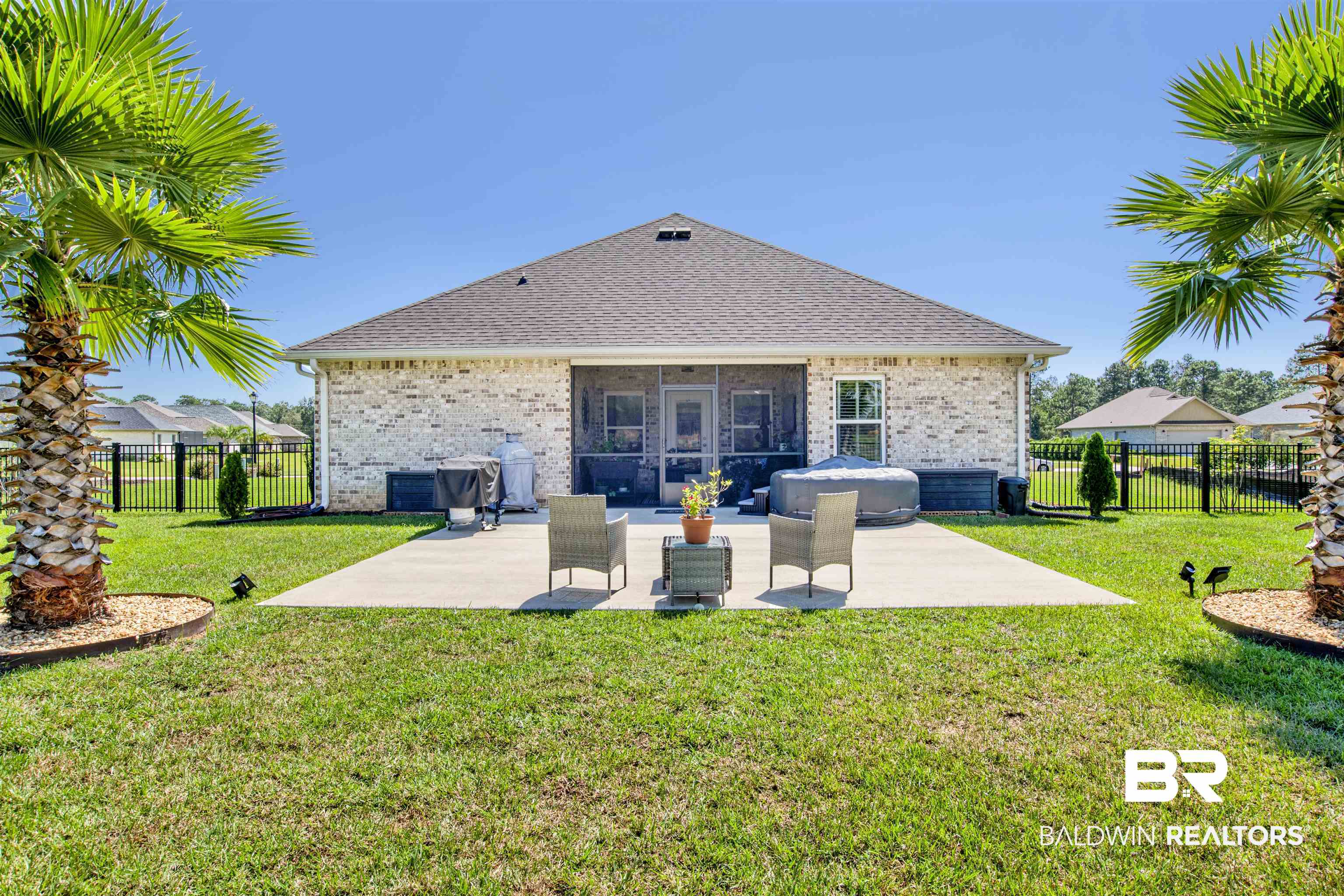 10113 Lakeview Drive Foley, AL 36535 - Photo 32 of 34 Rear view of house featuring a yard and a patio area