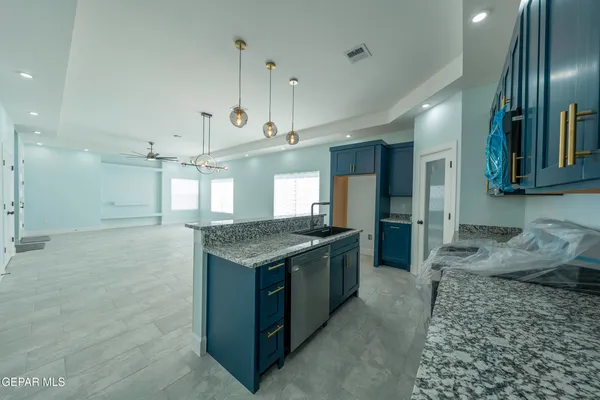 a bathroom with a granite countertop sink mirror and shower