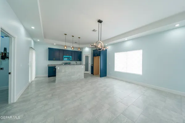 an empty room with closet and a chandelier fan