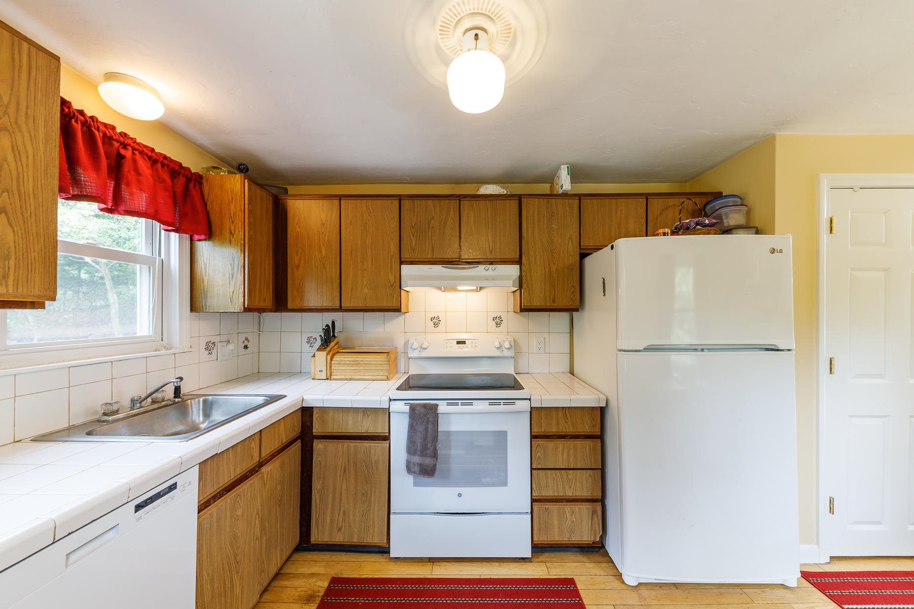 104 Valley Bars Road Bourne, MA 02532 - Photo 11 of 22 a kitchen with a refrigerator and a sink