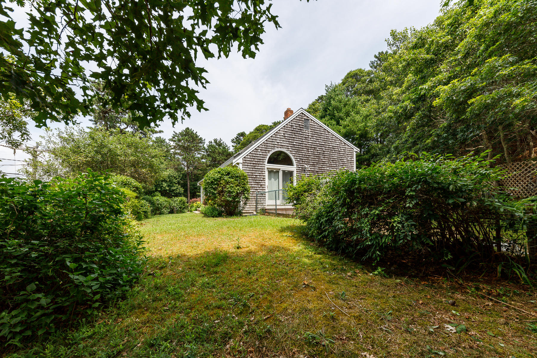 104 Valley Bars Road Bourne, MA 02532 - Photo 3 of 22 a front view of a house with yard and green space