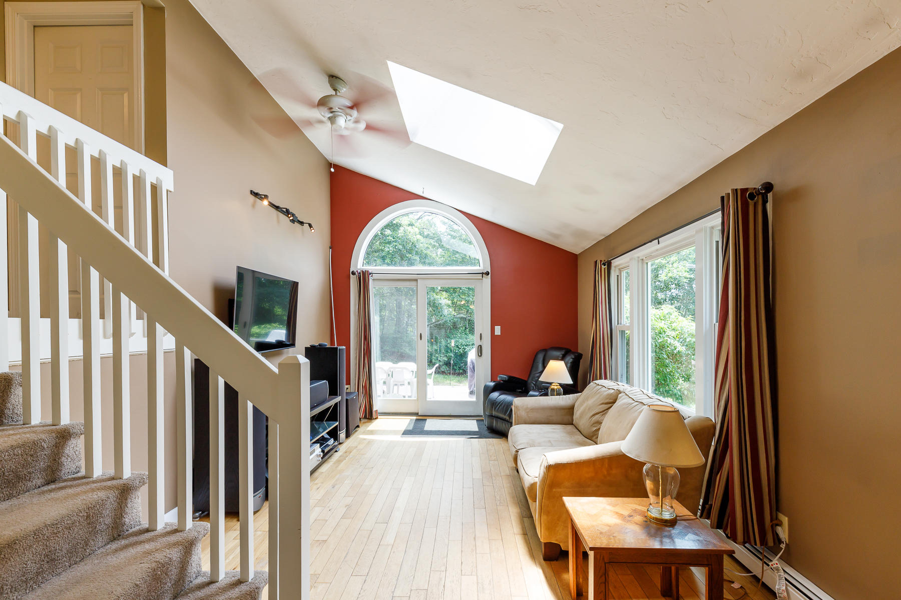 104 Valley Bars Road Bourne, MA 02532 - Photo 7 of 22 a living room with furniture a fireplace and a large window