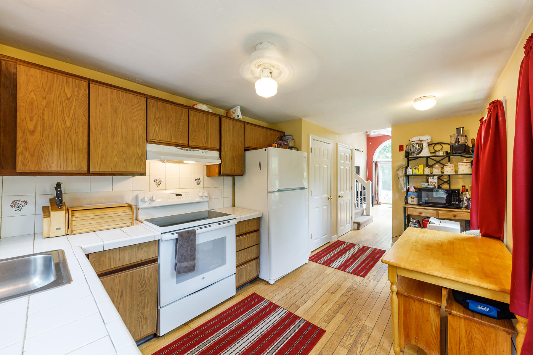 104 Valley Bars Road Bourne, MA 02532 - Photo 10 of 22 a kitchen with a refrigerator a stove top oven a sink and cabinets