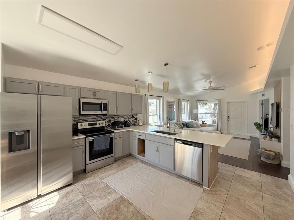 13272 Helm Street Largo, FL 33774 - Photo 3 of 20 a large kitchen with cabinets