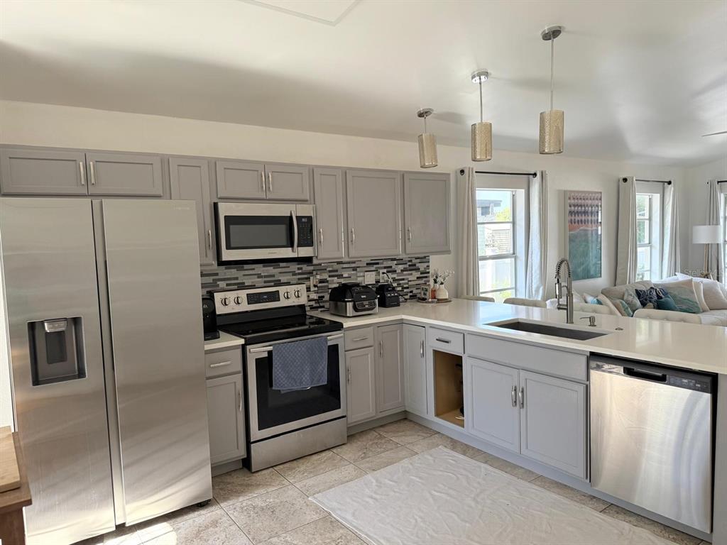 13272 Helm Street Largo, FL 33774 - Photo 4 of 20 a kitchen with a sink stove and refrigerator
