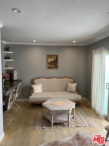 a living room with furniture a rug and a window