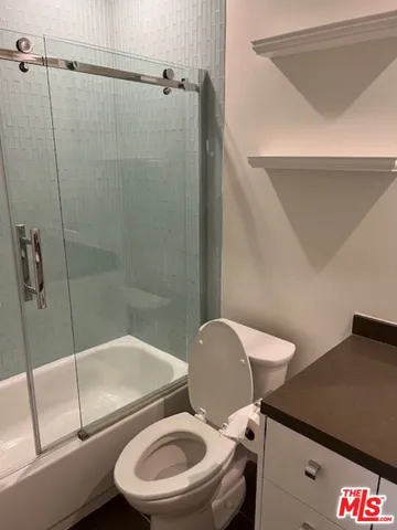 a bathroom with a toilet and a shower