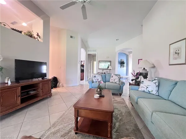 a living room with furniture and a flat screen tv