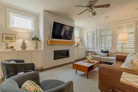 a living room with furniture a flat screen tv and a fireplace