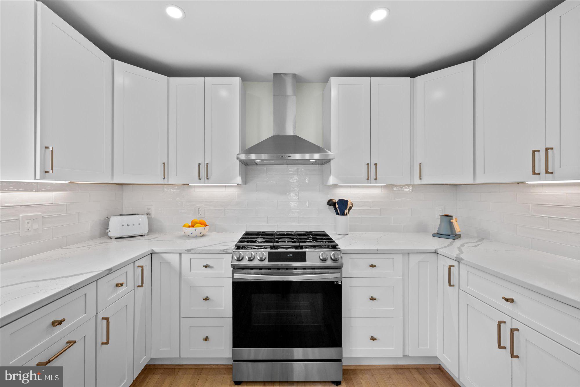 6700 Rannoch Road Bethesda, MD 20817 - Photo 13 of 36 a kitchen with white cabinets and white appliances