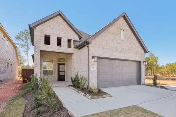 a large kitchen with stainless steel appliances a large counter top a wooden floor and a window