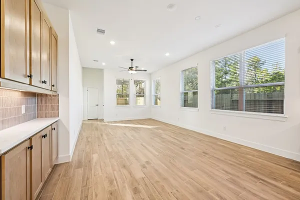 a view of a room with wooden floor