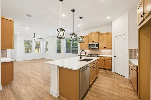 a view of a kitchen with a sink and a refrigerator