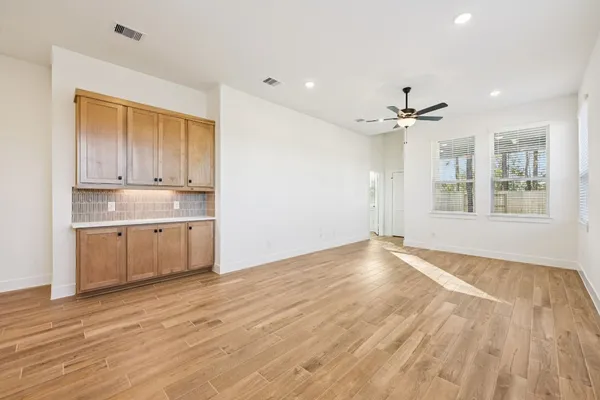 a view of a kitchen with wooden floor and a window