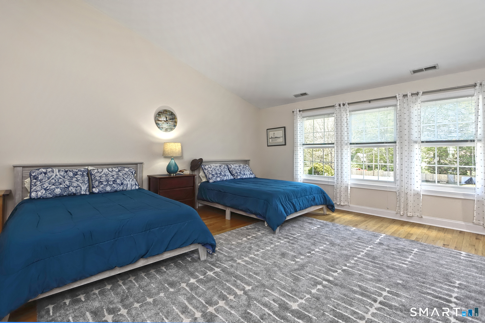 102 Lantern Court, Unit 102 Clinton, CT 06413 - Photo 30 of 36 a bedroom with two beds and a large window