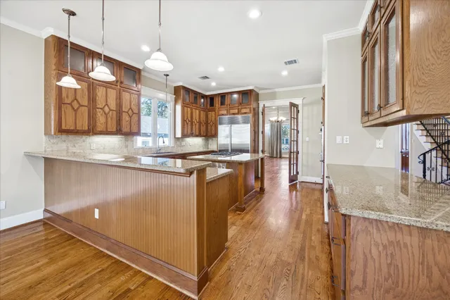 a kitchen with stainless steel appliances granite countertop a stove a sink and a refrigerator