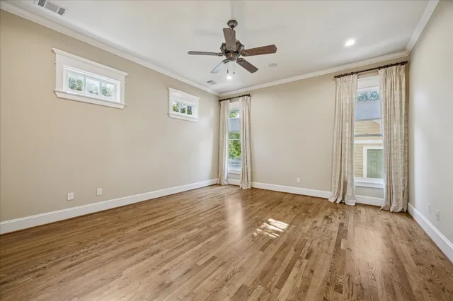 a view of an empty room and wooden floor