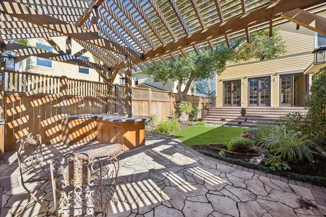 a view of a house with backyard and sitting area