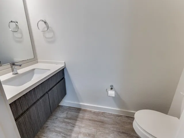 a bathroom with a sink a toilet and a mirror