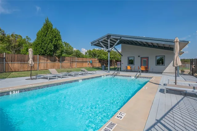 a swimming pool with outdoor seating and yard