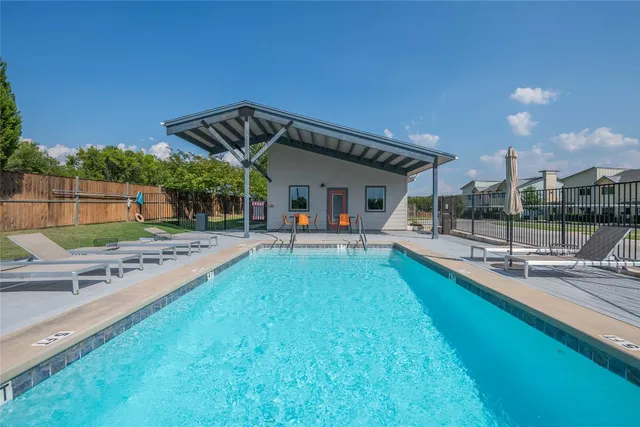 a view of a house with swimming pool and sitting area