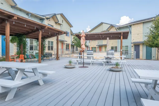 a view of living room with wooden floor and large windows
