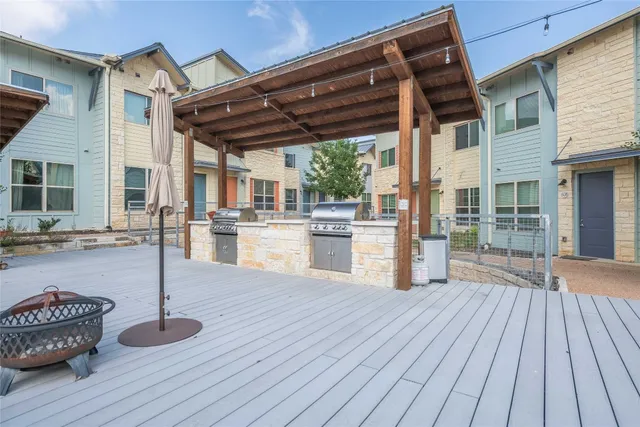 a swimming pool with outdoor seating and wooden floor