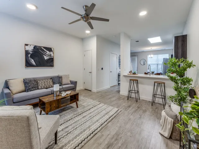 a living room with furniture and a wooden floor
