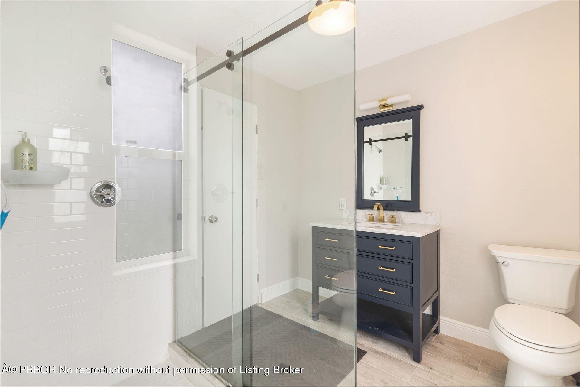 2770 E Road Loxahatchee, FL 33470 - Photo 25 of 51 a bathroom with a toilet a sink and shower