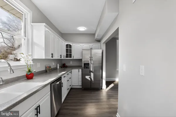 a kitchen with a sink stove and refrigerator