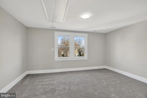 a bedroom with bed and window