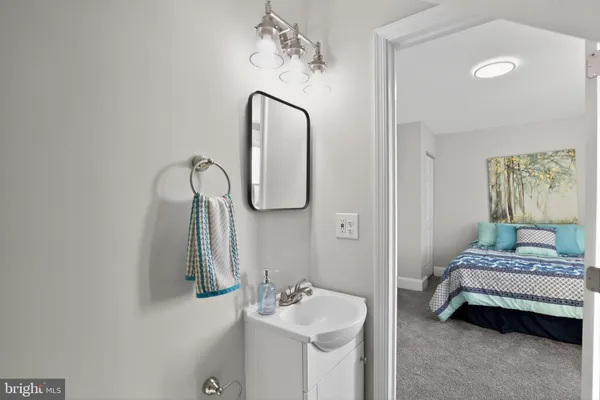 a bathroom with a toilet sink and mirror