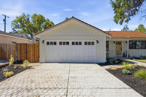 a front view of a house with garden