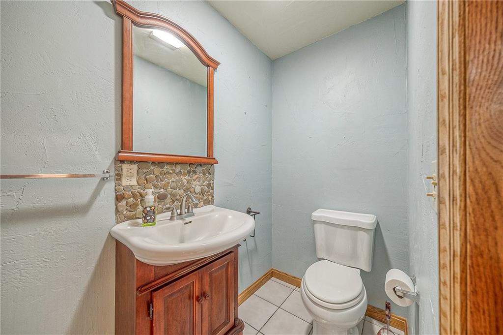 156 Critchlow School Road Renfrew, PA 16053 - Photo 34 of 49 a bathroom with a sink toilet and mirror