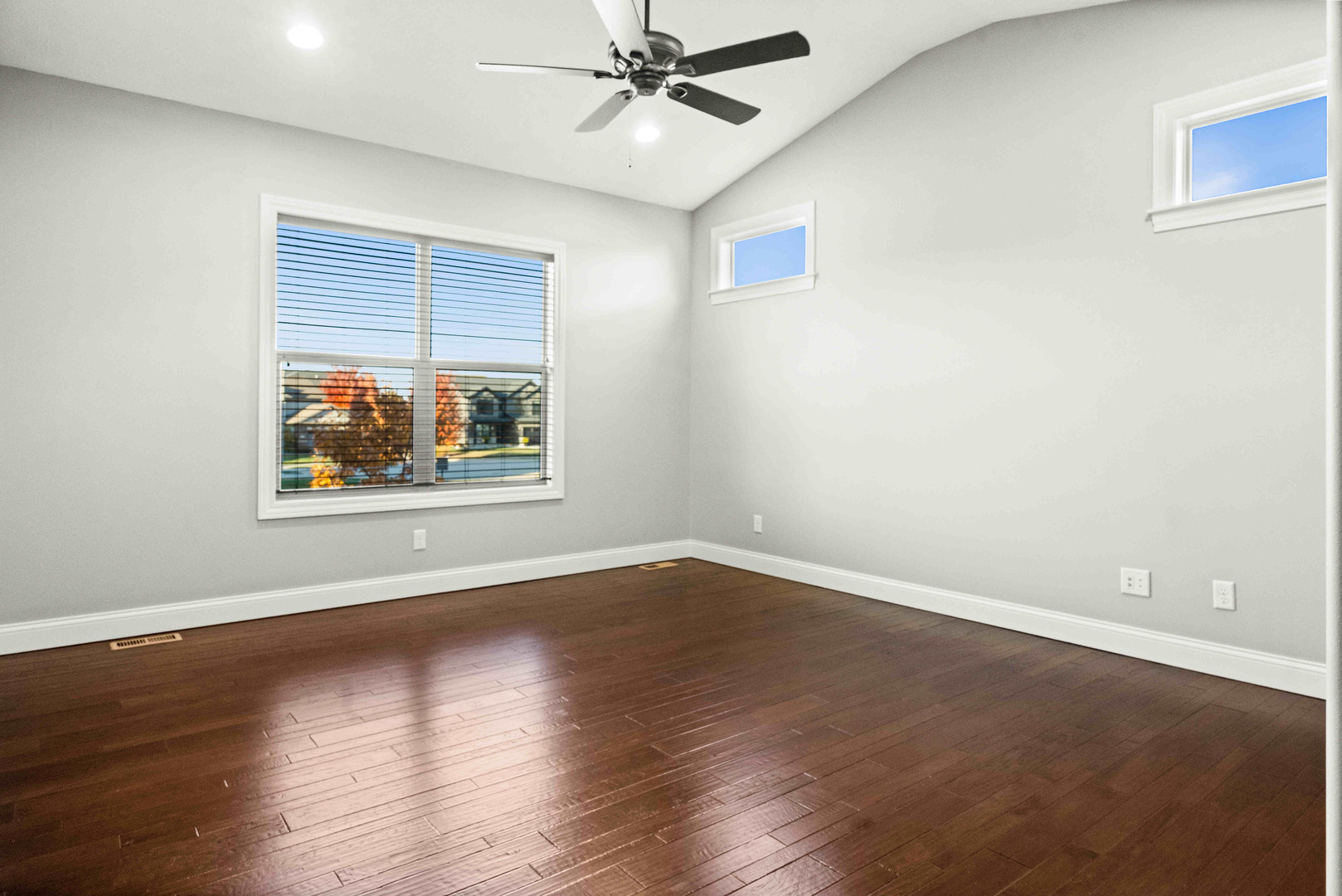 2526 Red Rock Road Normal, IL 61761 - Photo 20 of 38 an empty room with wooden floor ceiling fan and windows