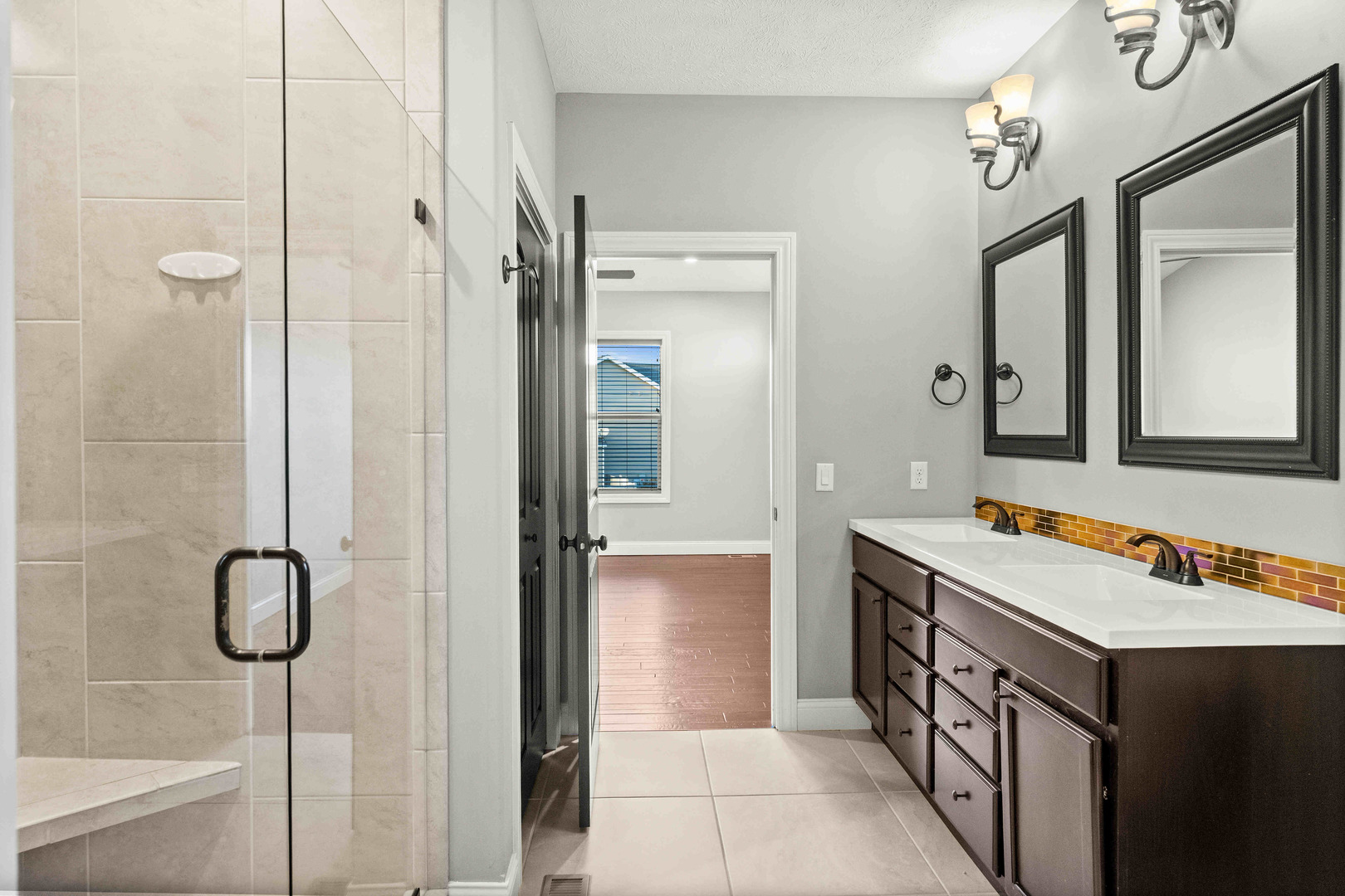 2526 Red Rock Road Normal, IL 61761 - Photo 24 of 38 a bathroom with a granite countertop sink a mirror and a shower