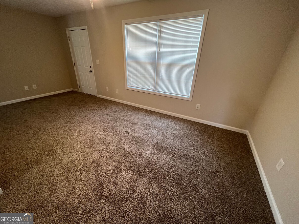 158 Elder Drive Southeast, Unit B Social Circle, GA 30025 - Photo 2 of 19 an empty room with a window