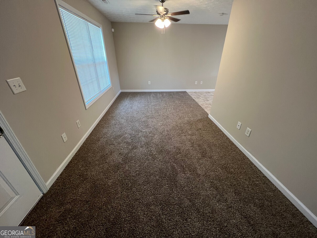 158 Elder Drive Southeast, Unit B Social Circle, GA 30025 - Photo 3 of 19 wooden floor in an empty room with a window