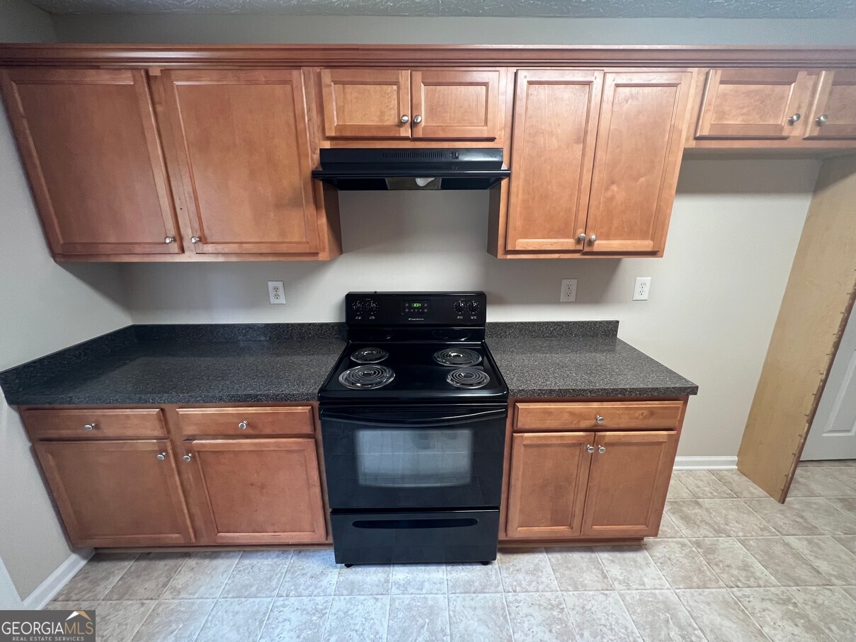 158 Elder Drive Southeast, Unit B Social Circle, GA 30025 - Photo 7 of 19 a stove top oven sitting inside of a kitchen