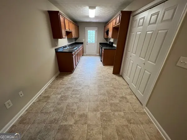 a kitchen with a refrigerator stove and a sink